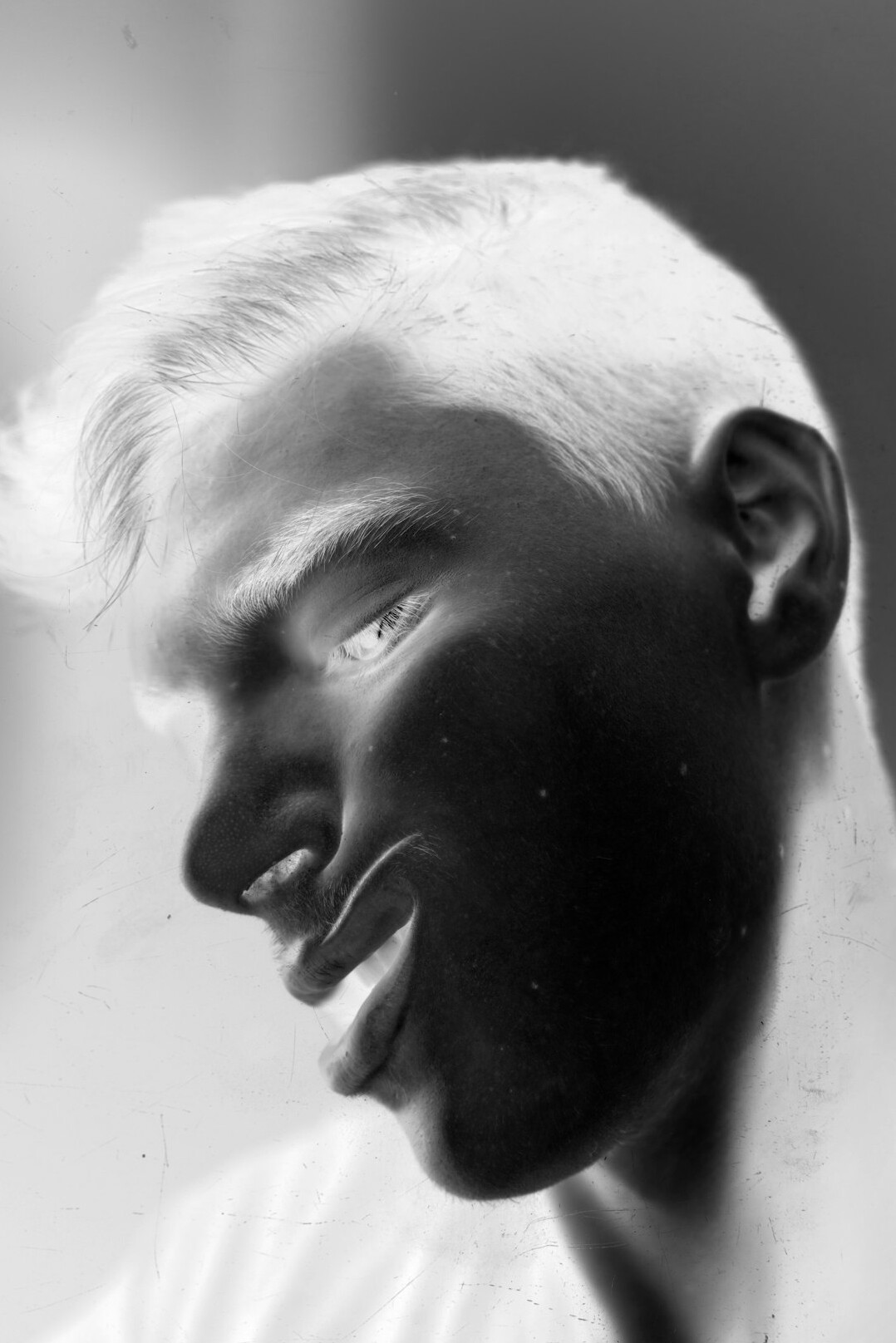 Studio portrait of a smiling man with short hair